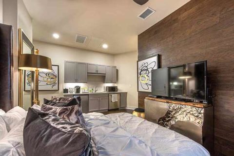 guest suite bedroom with hardwood-inspired flooring