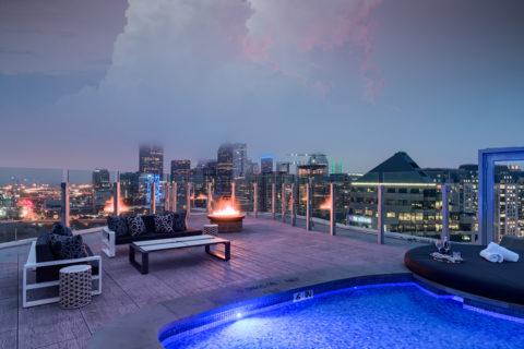 Rooftop fire pit with comfortable seating and the skyline